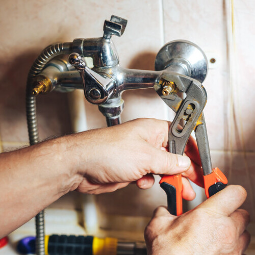plumber fixing a shower leak